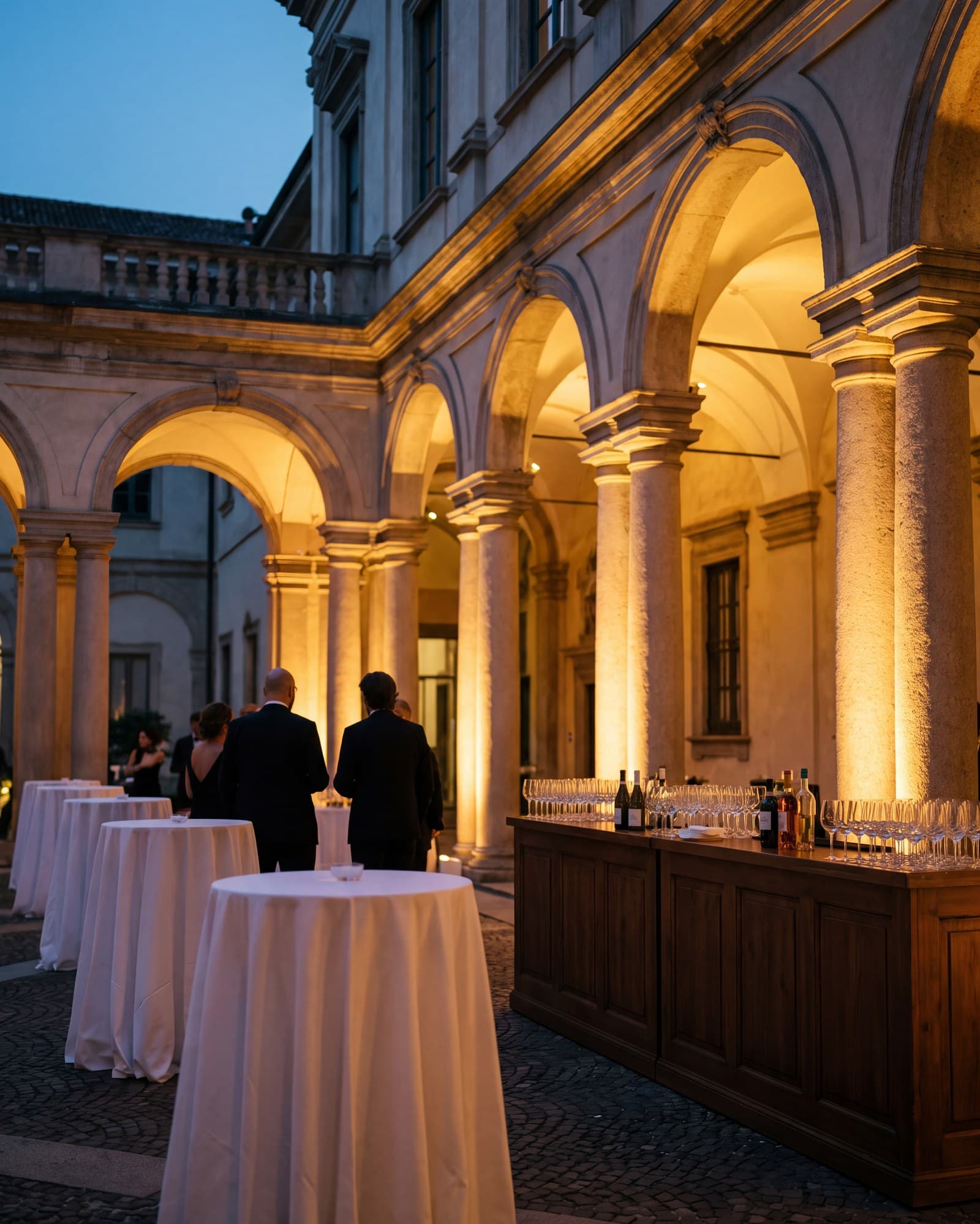 A palazzo courtyard set up for a corporate cocktail in the evening.